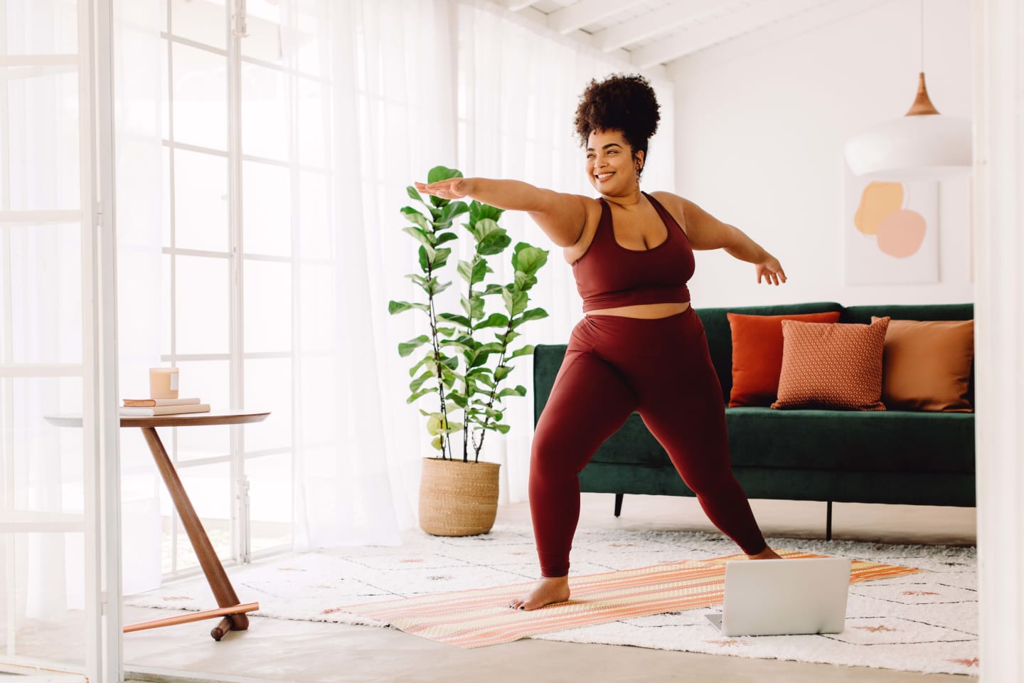 Woman doing yoga in her living room