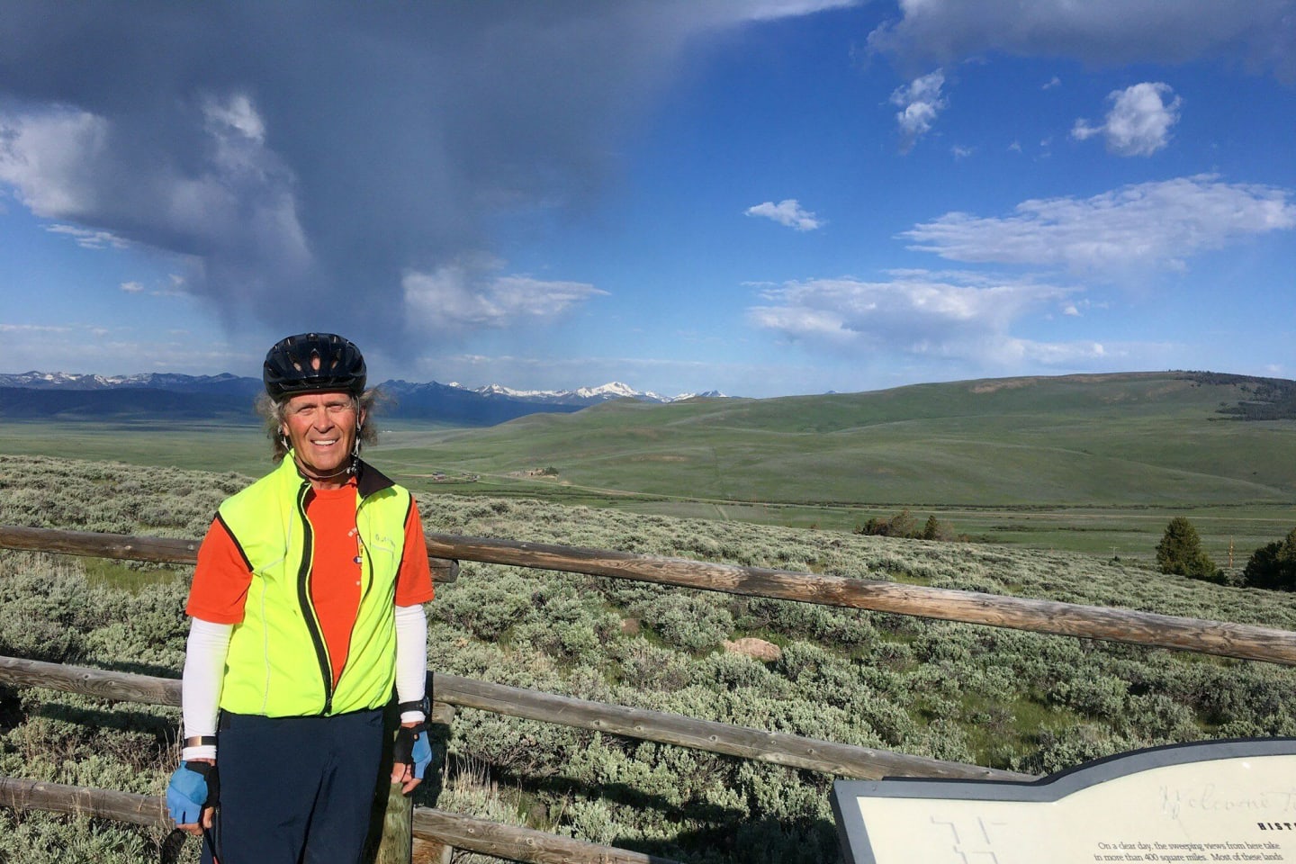 A man standing in front of a scenic overlook