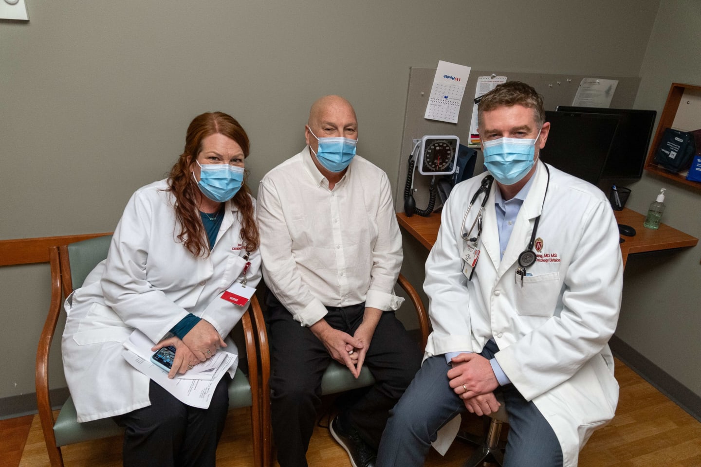 Gary Davey sitting in an exam room with his oncology providers