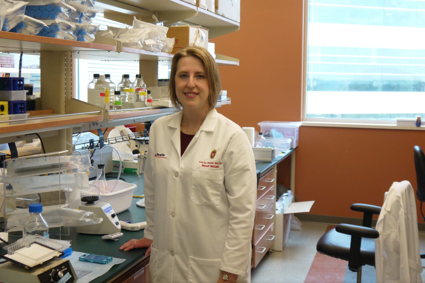 Doctor Amy Fowler wearing a white coat in a lab