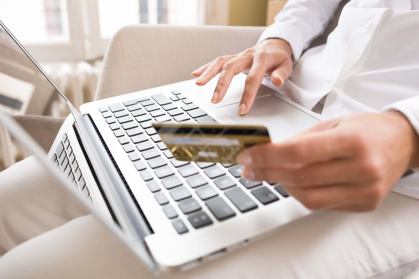 A closeup of a person entering a credit card number into a computer