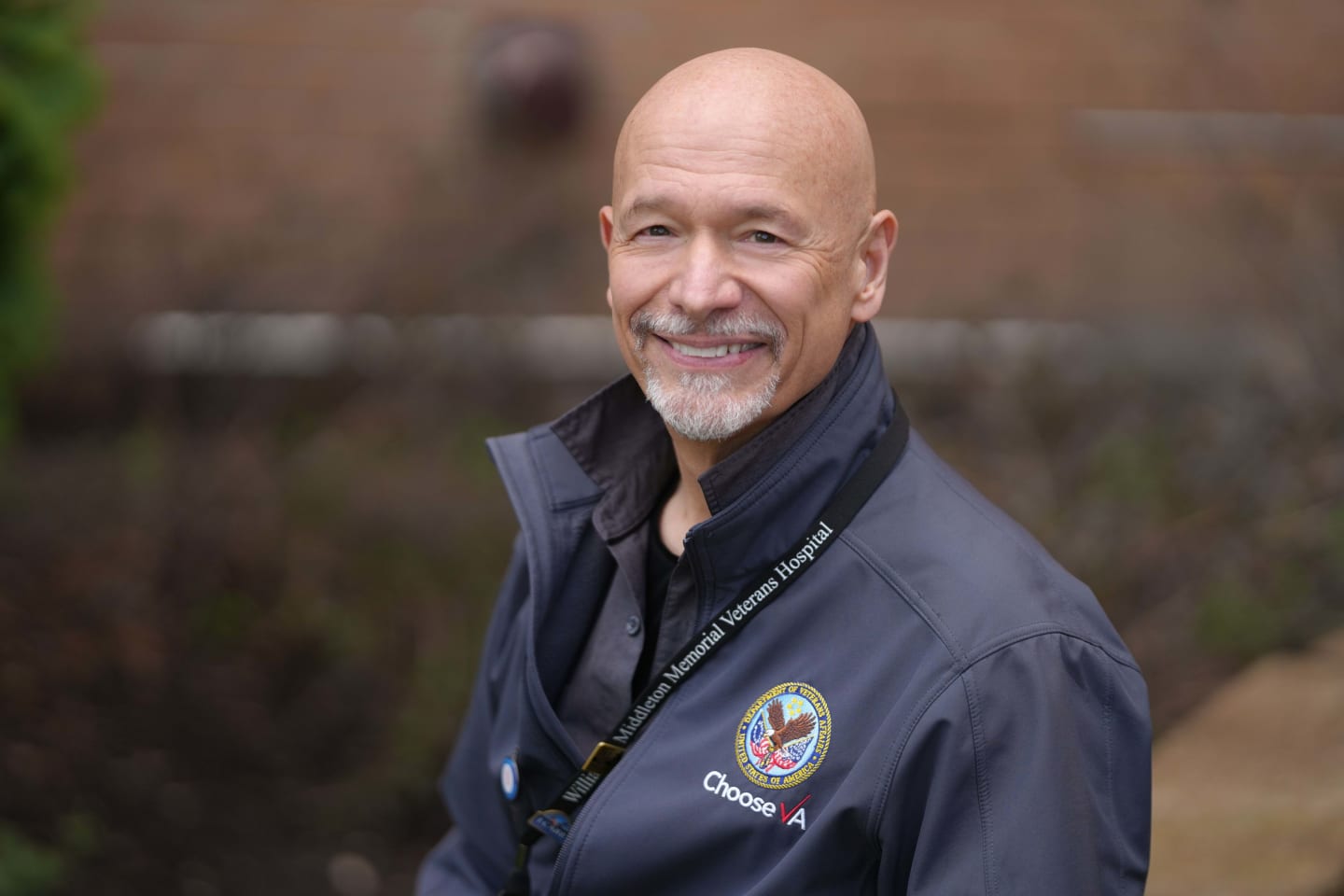 A man wearing a jacket and smiling.