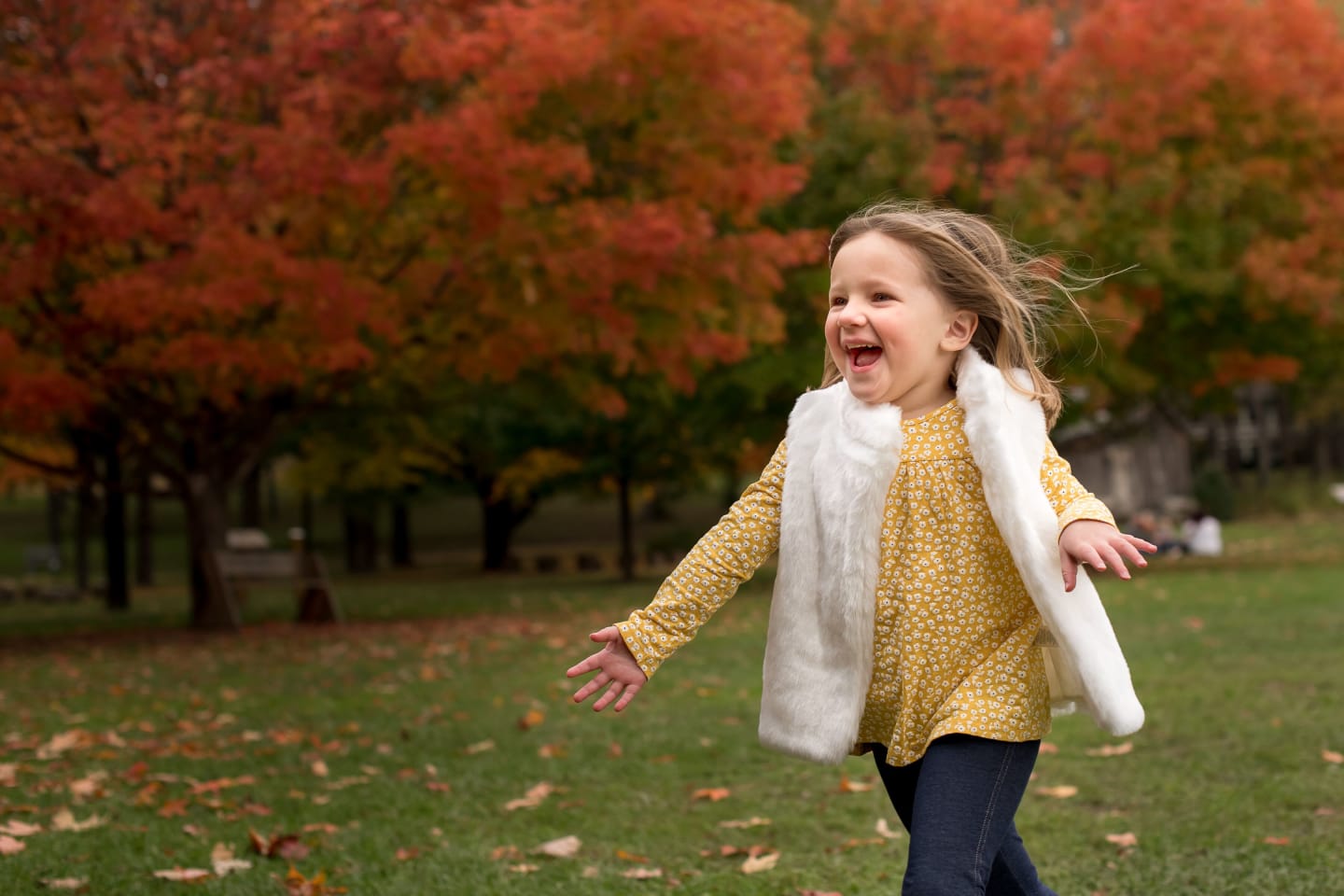 Child running outdoors during the fall