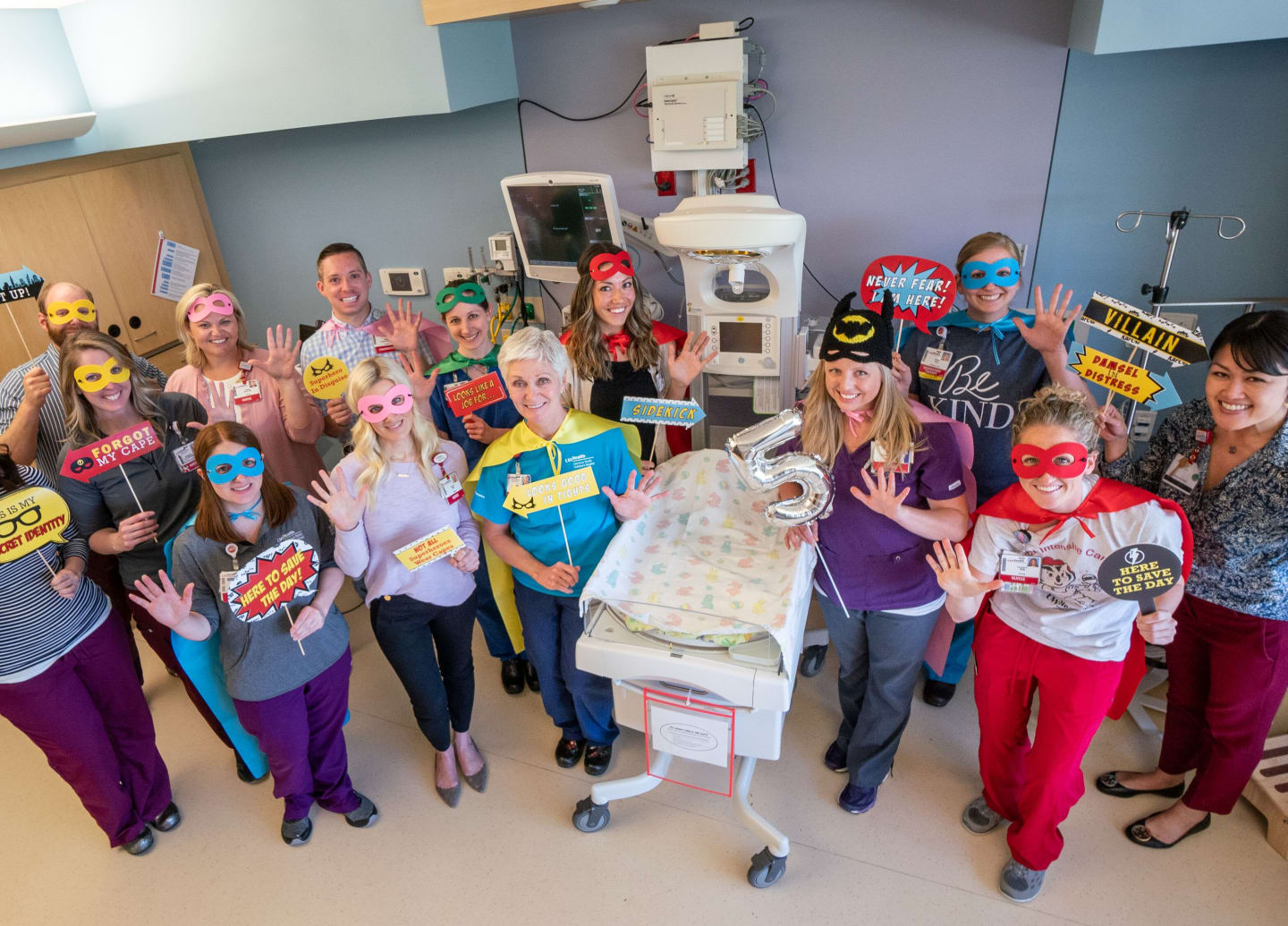 A group of neonatal intensive care unit nurses wearing superhero costumes