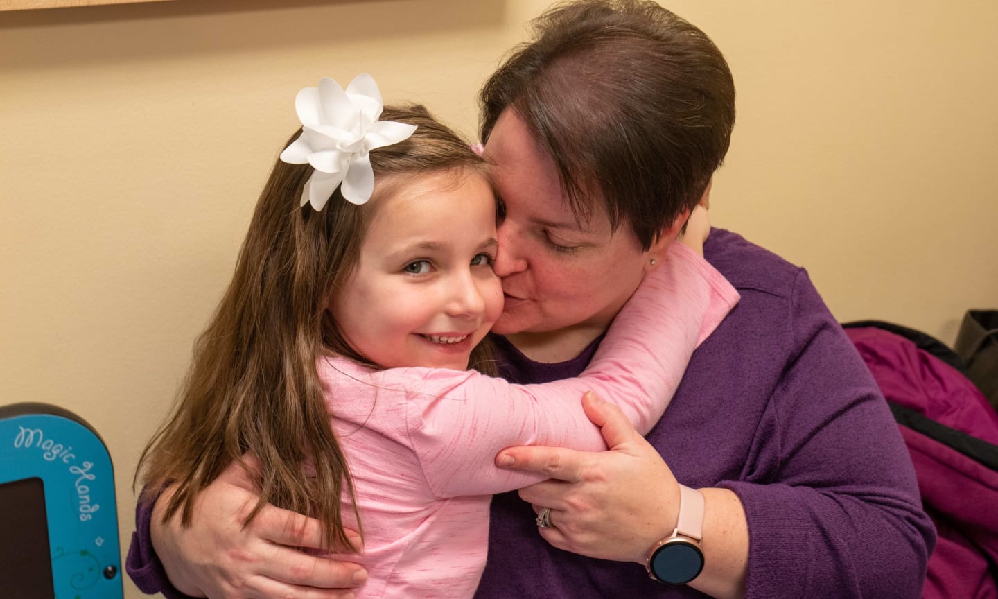 Pediatric patient hugging mom