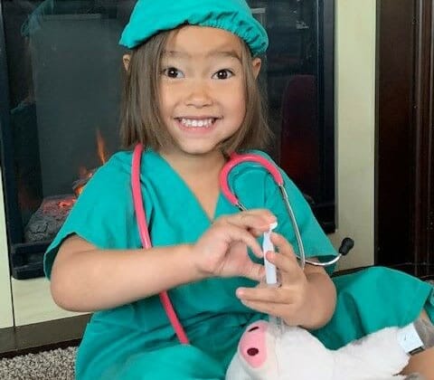 Child Ivy Van Dong wearing a surgeon costume