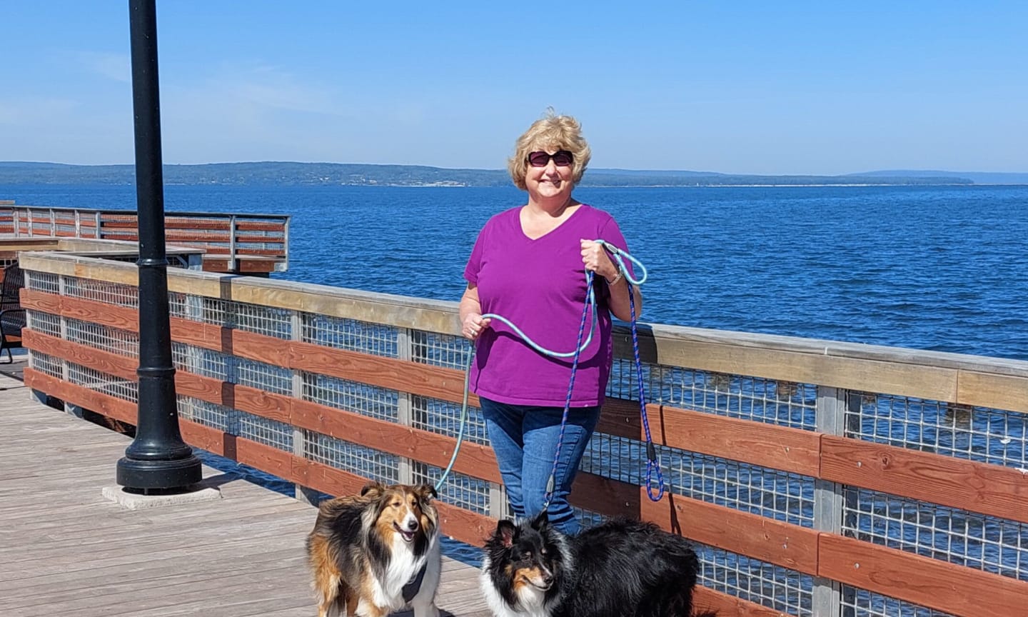 Marcia Budde outside walking her two dogs.