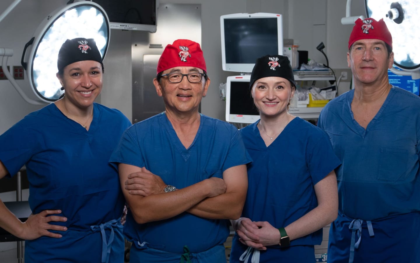 Four urology surgeons in an operating room