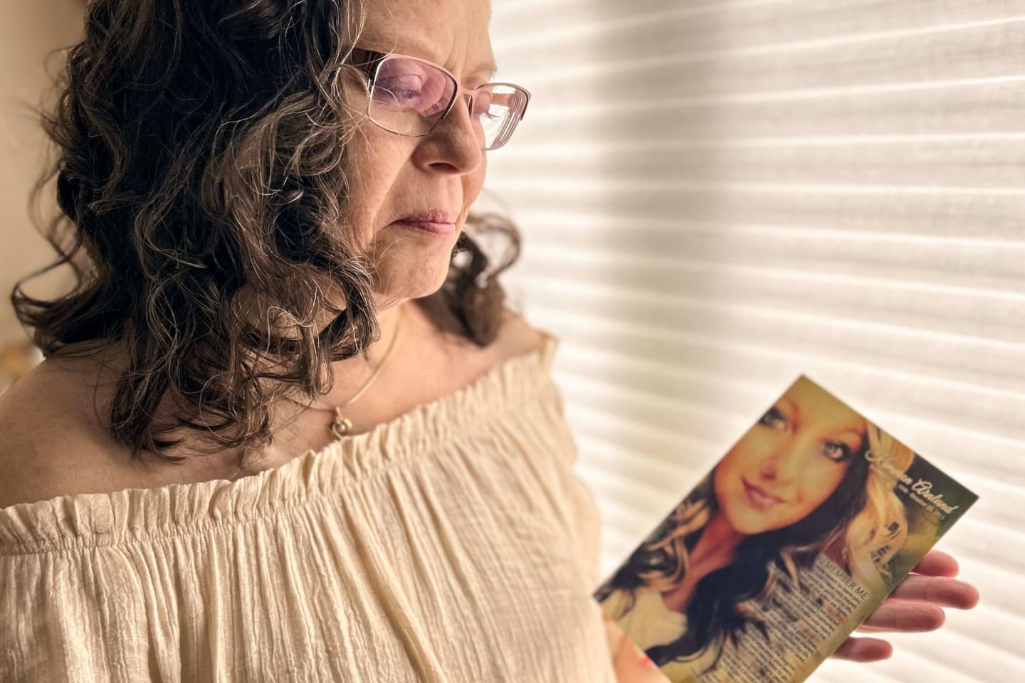 Deirdre Croal holding photo of donor Kameron Arnlund