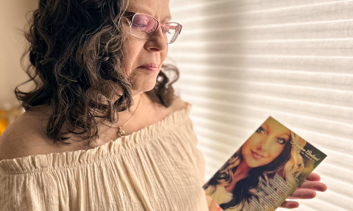 Deirdre Croal holding photo of donor Kameron Arnlund