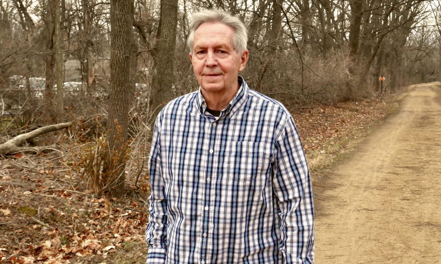 Rob Zaleski walking down a dirt path in the autumn