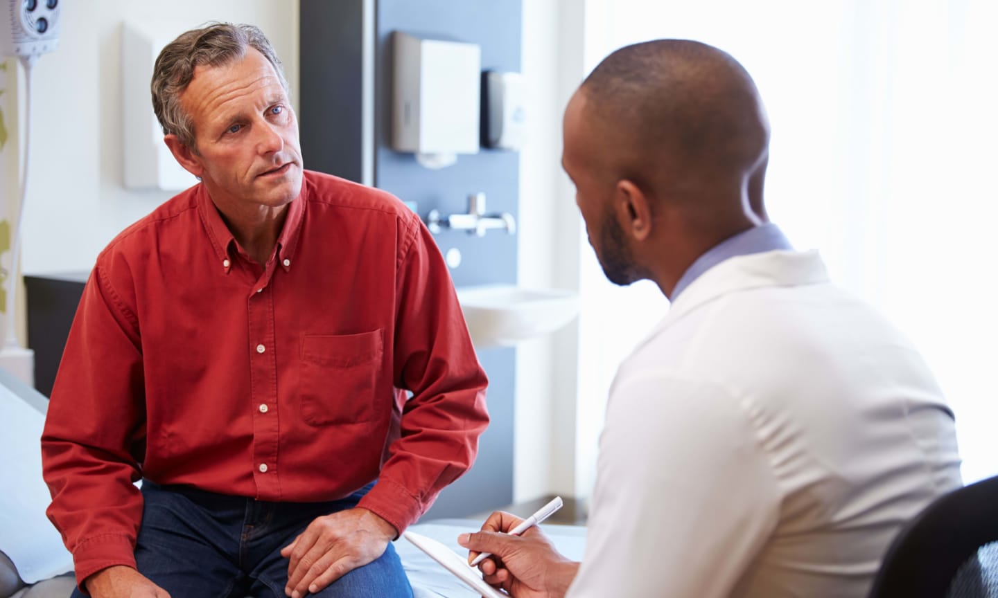 Doctor consulting with a man in office