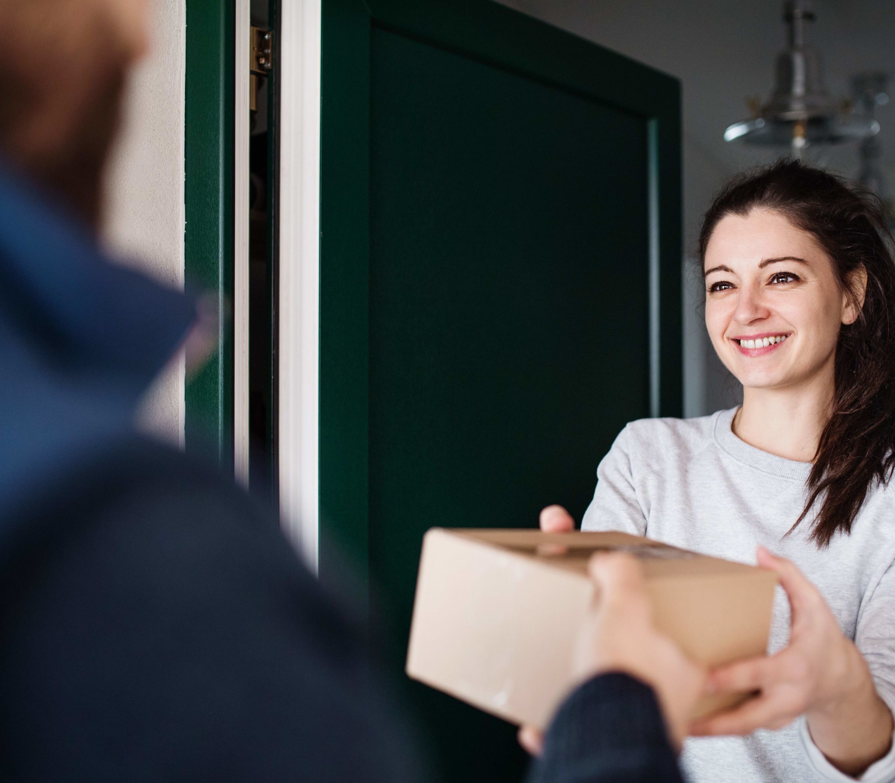 Individual receiving a package being delivered 