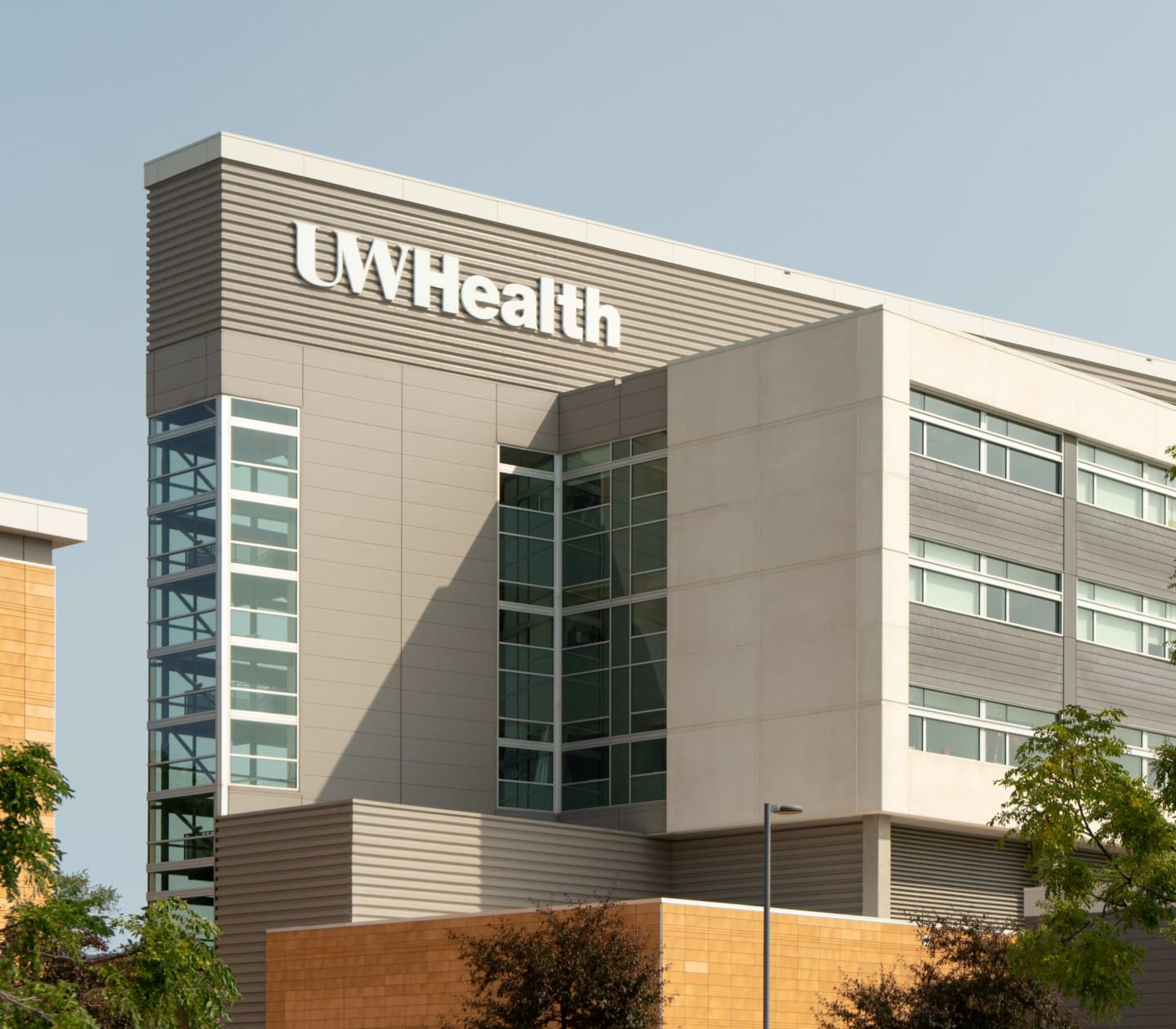 The gray exterior and white "UW Health" sign of East Madison Hospital