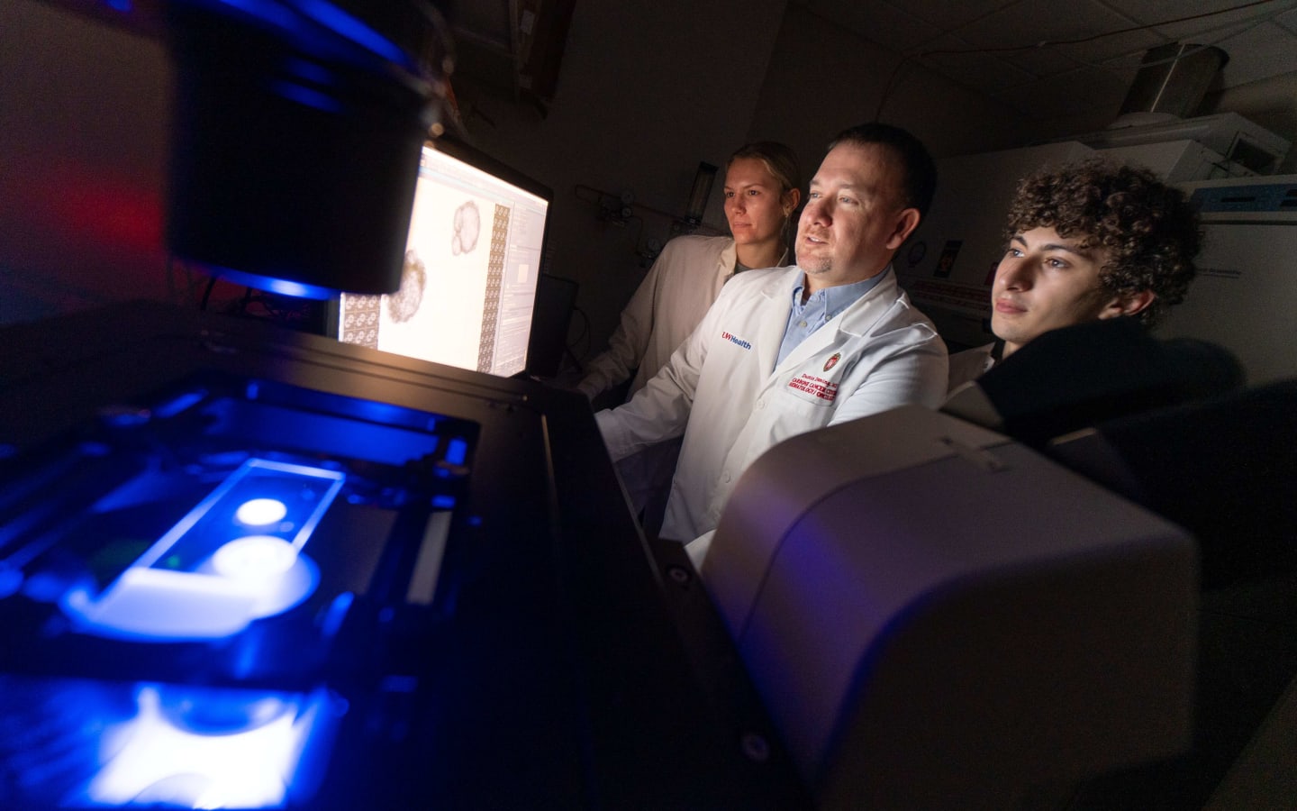 Doctors looking at a screen in a lab.