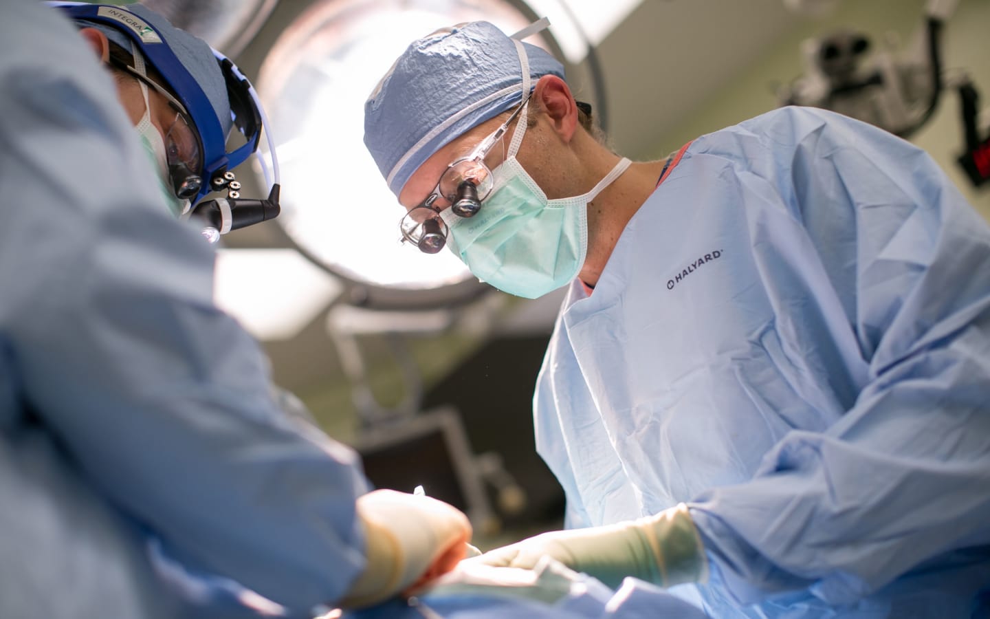 A surgeon working on a patient in an operating room