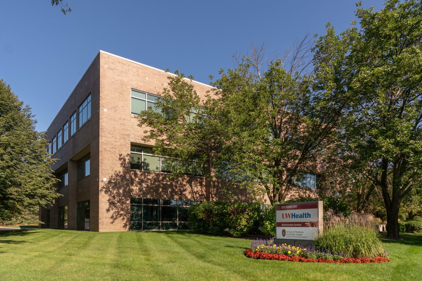 A wide shot of the brick administration building on 1212 Deming Way