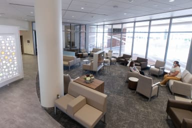 Modern furniture in front of windows inside the patient waiting area at the Pleasant T. Rowland Transplant Clinic