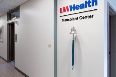 A bell mounted to a wall in the Pleasant T. Rowland Transplant Clinic that is used for patients to celebrate treatment milestones