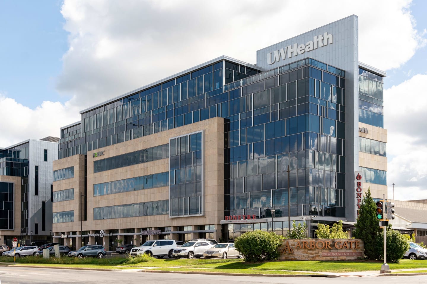 Wide photo of the mostly glass exterior of the Arbor Gate clinic