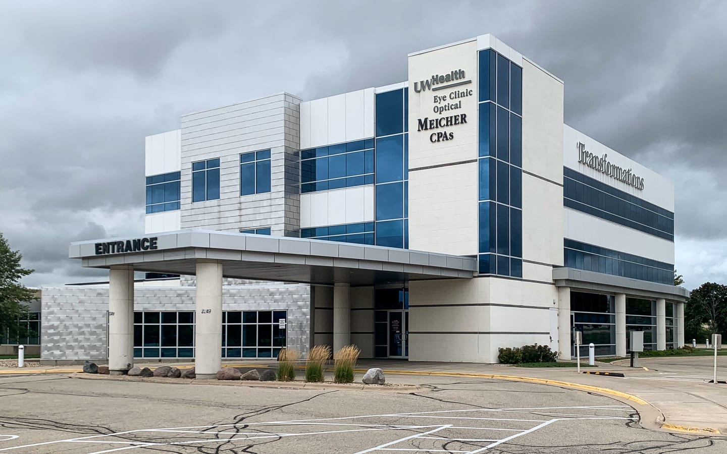 A multi-story white and glass building