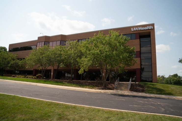 Wide photo of the brick and glass Administrative Services building on 8501 Excelsior Drive