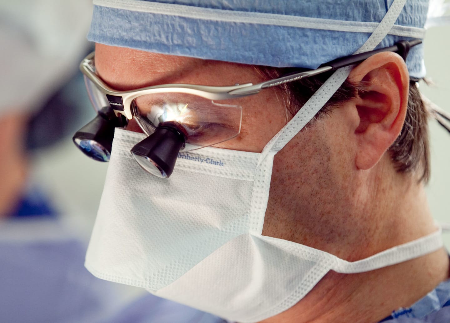 A doctor wearing a mask in an operating room
