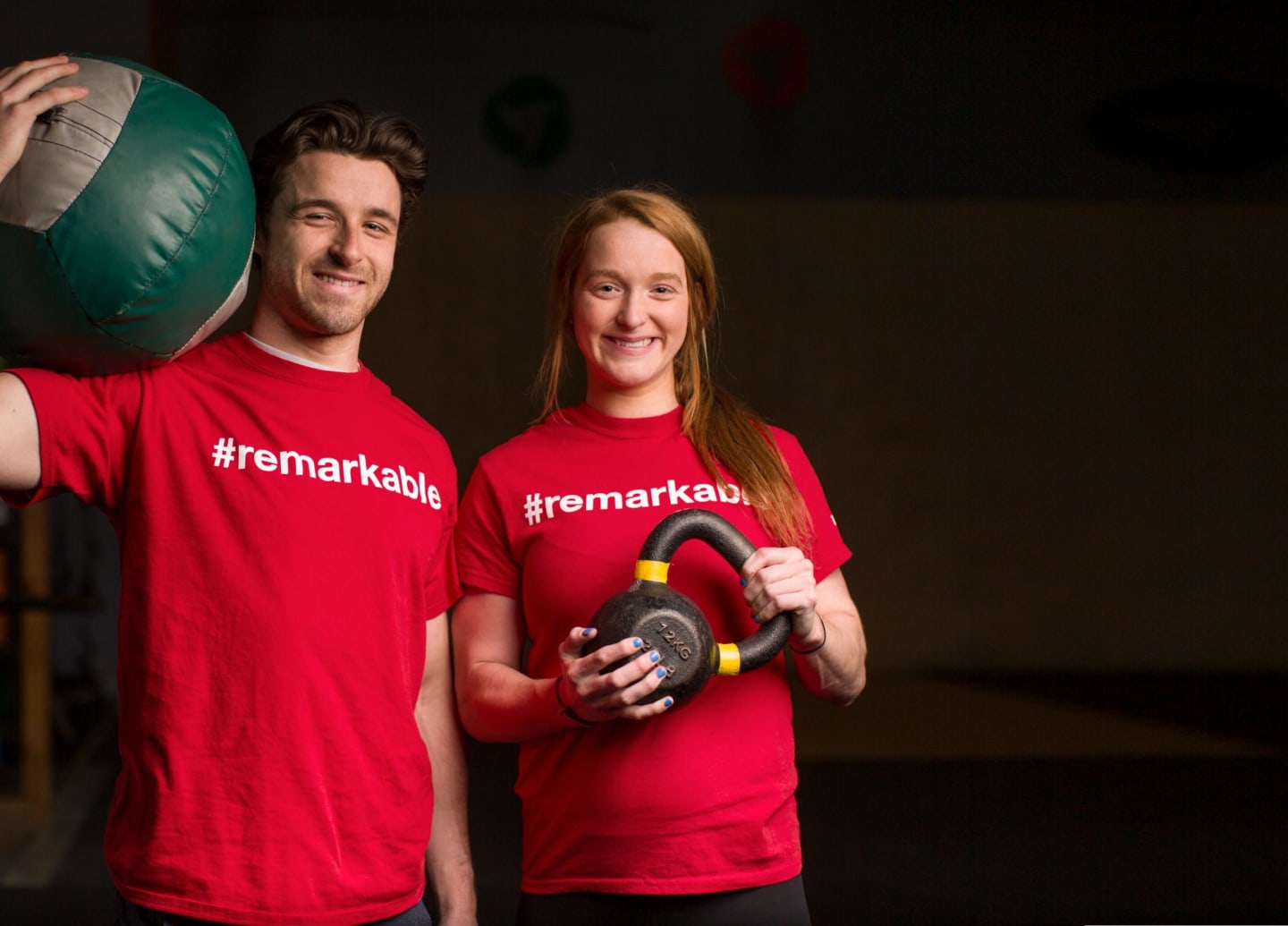 Two people holding exercise equipment