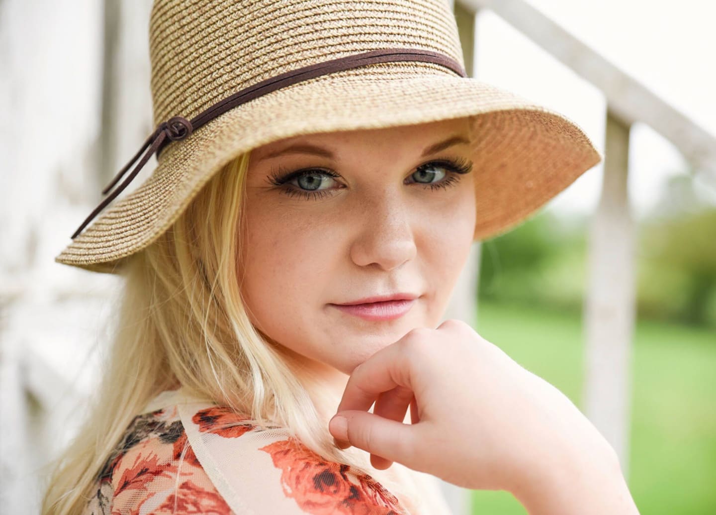 Breelyn Neuroth, smiling outdoors in a sun hat.