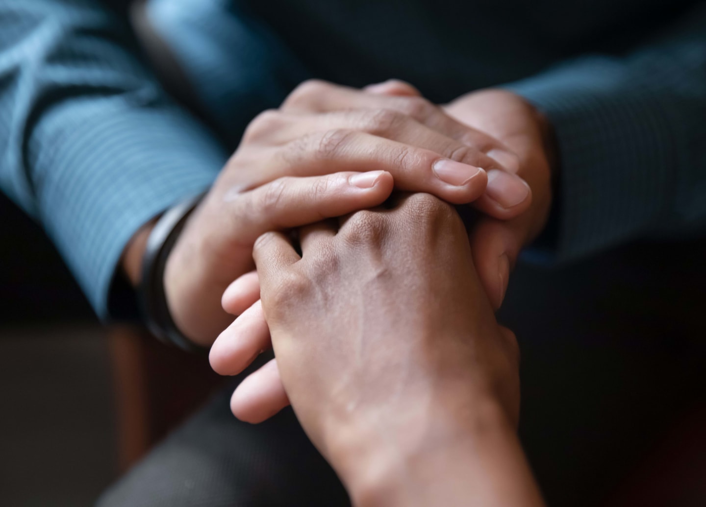 Close up of young couple hold hands talking sharing secrets showing love and care, husband and wife have tender close moment together, demonstrate support and understanding