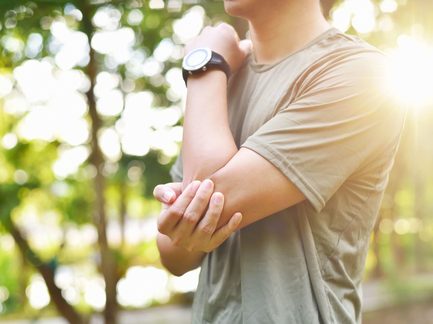 A close-up of a person holding their elbow