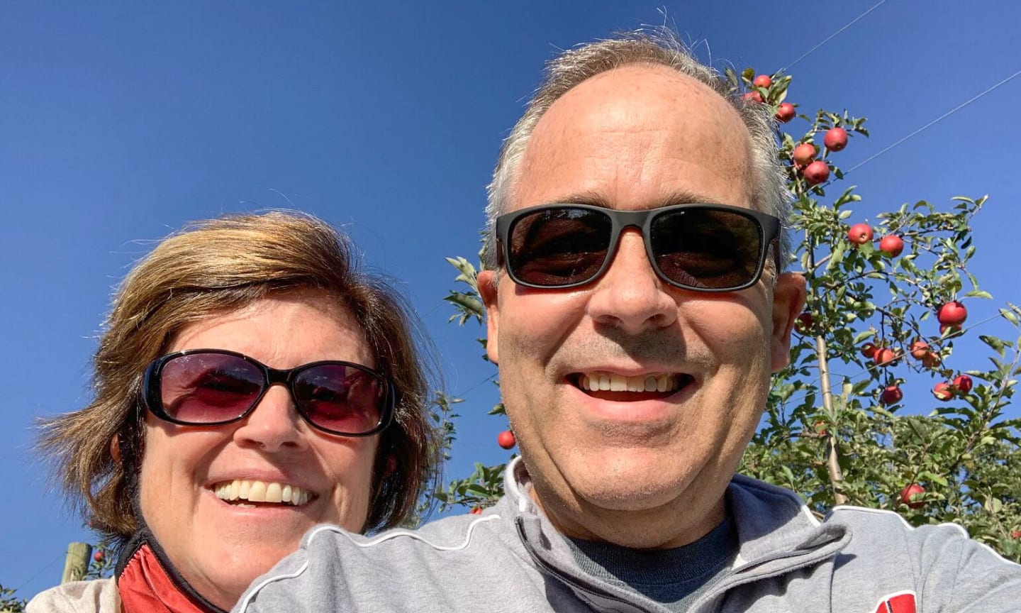 Joe Murray and his wife Janet outside on a clear day, wearing sunglasses