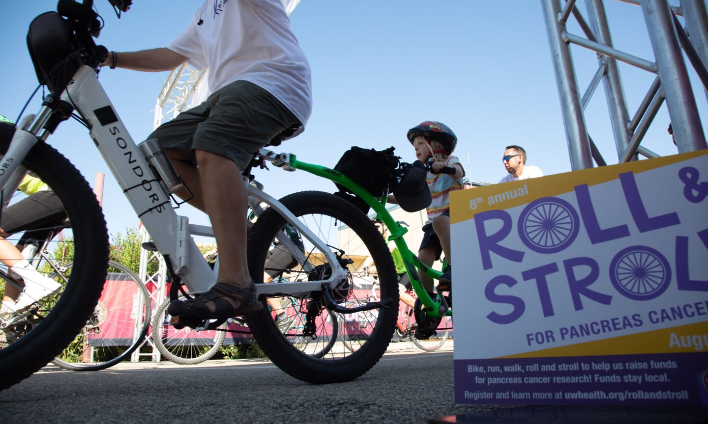 Individual on a bike at the starting line of Roll & Stroll event 