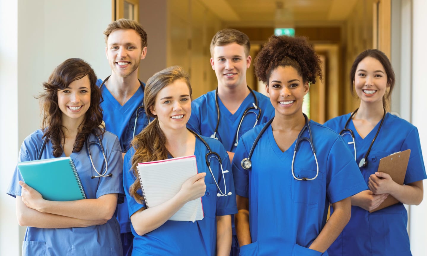 Diverse group of medical staff dressed in blue scrubs