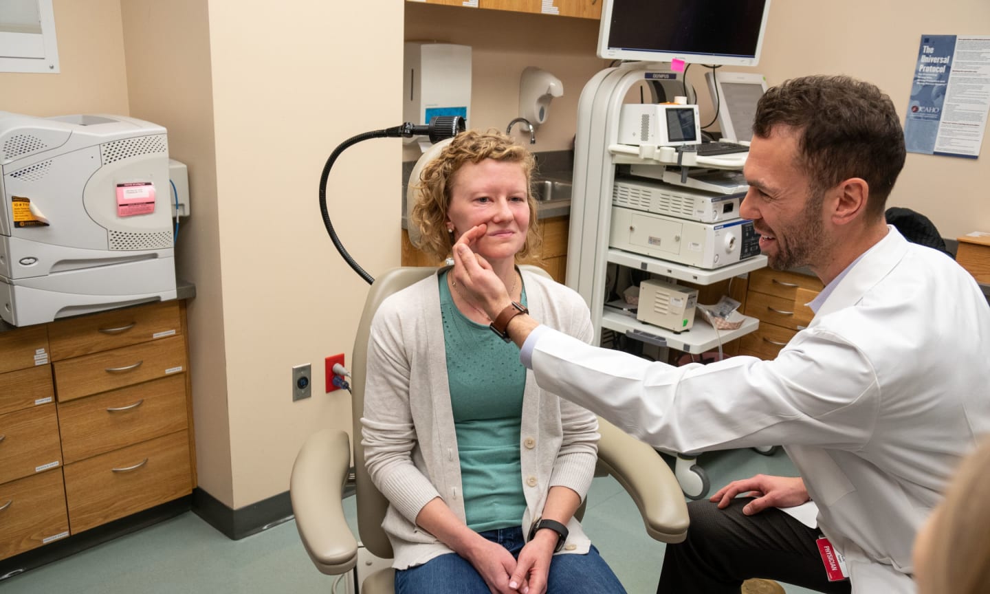 Doctor examining a patient's face