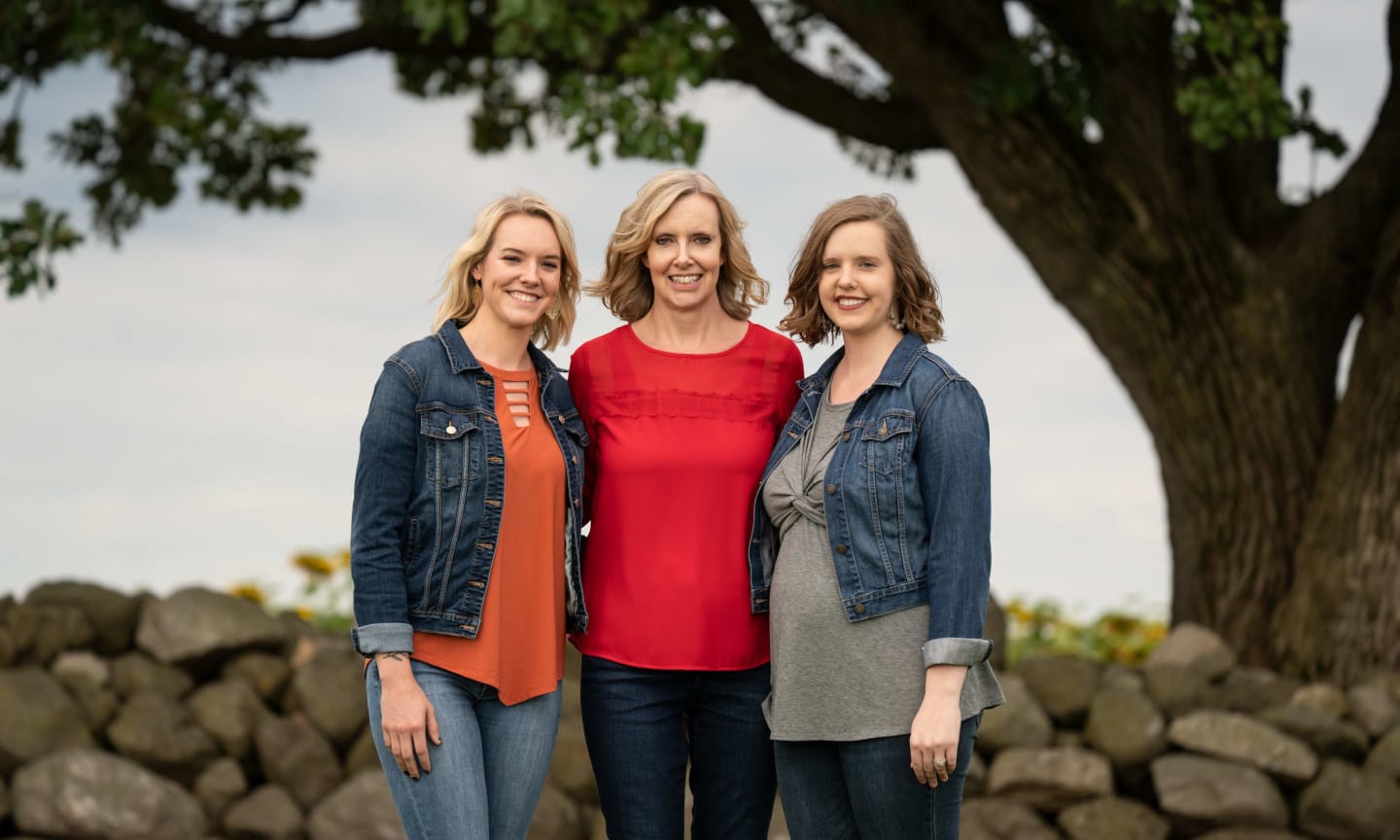 Amy standing between her twin daughters Lindsay and Holly