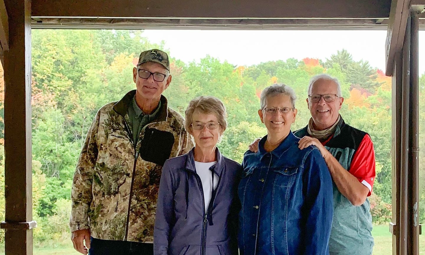 Two couples standing in a shelter