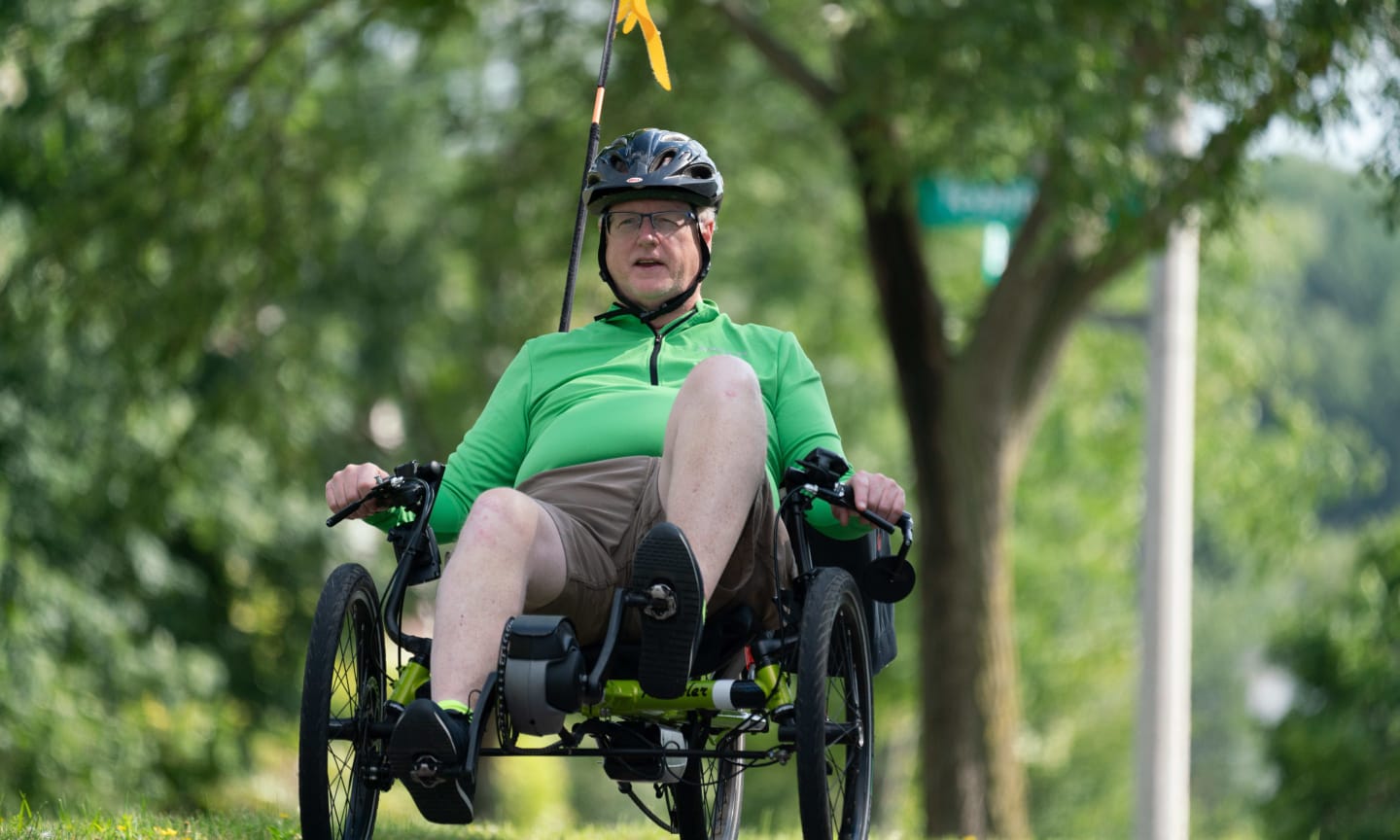 Mike Bradley riding his bike outdoors. He is now enjoying life again after a close call caused by a stroke.