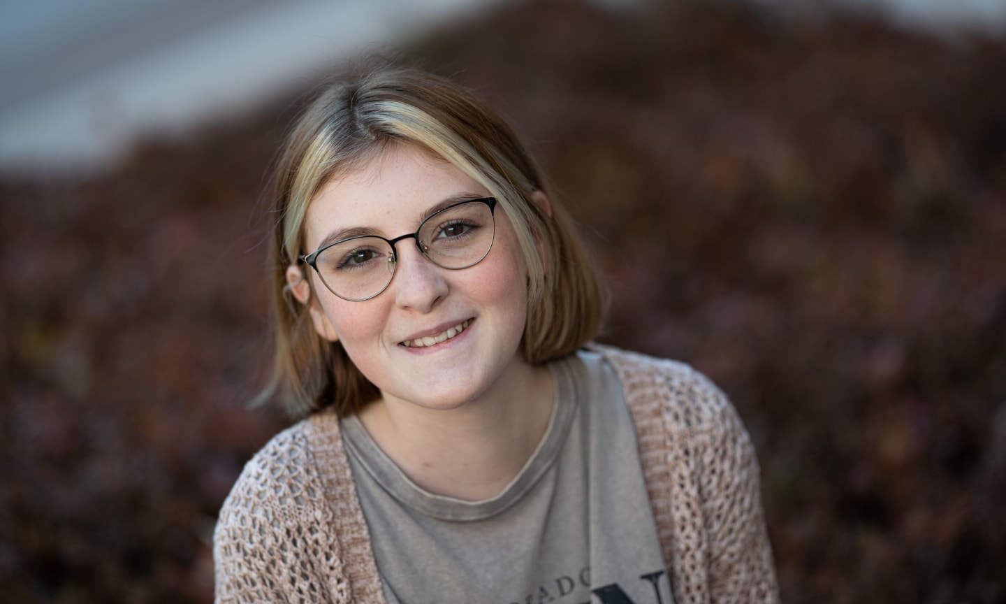 Stephanie Beyer portrait wearing glasses and a cardigan sweater