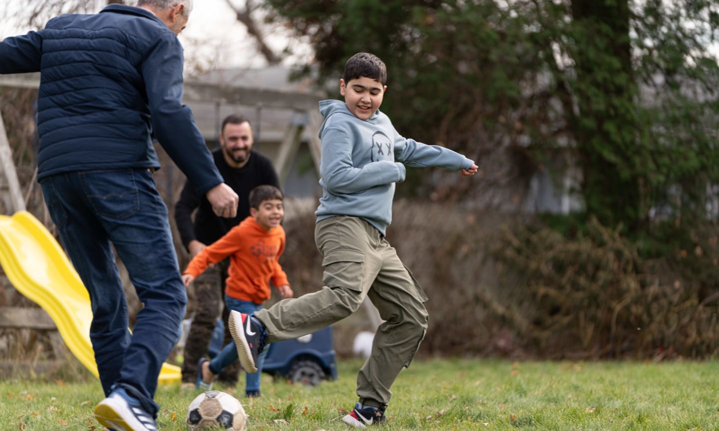 Sezar and his family play soccer in their backyard in Rockford, Ill.