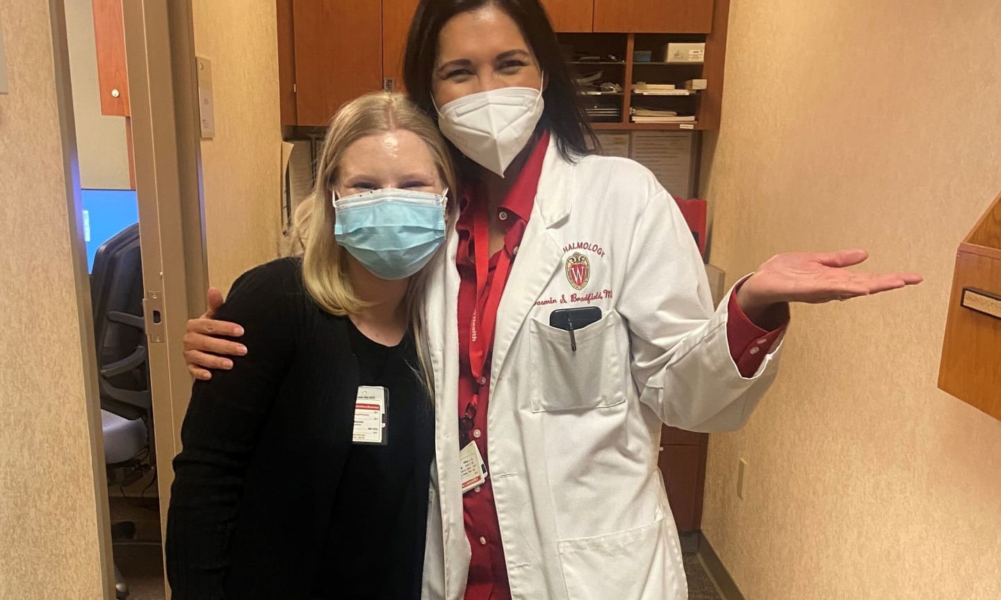 Veronica Blumer and Doctor Yasmin Bradfield standing in a hallway, wearing face masks