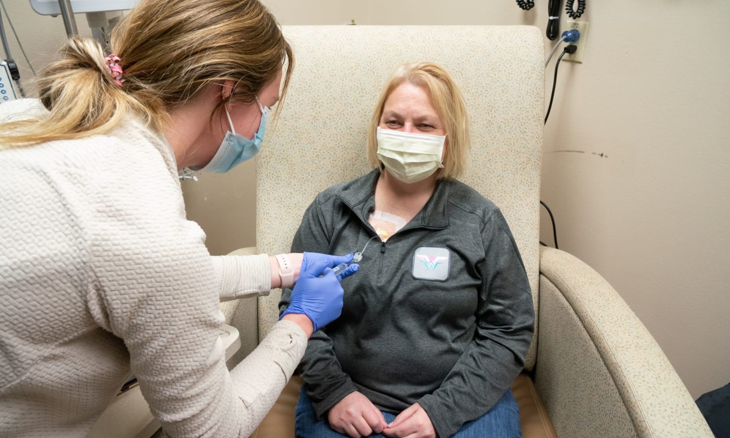 Sarah Smith receiving chemotherapy in a clinic.