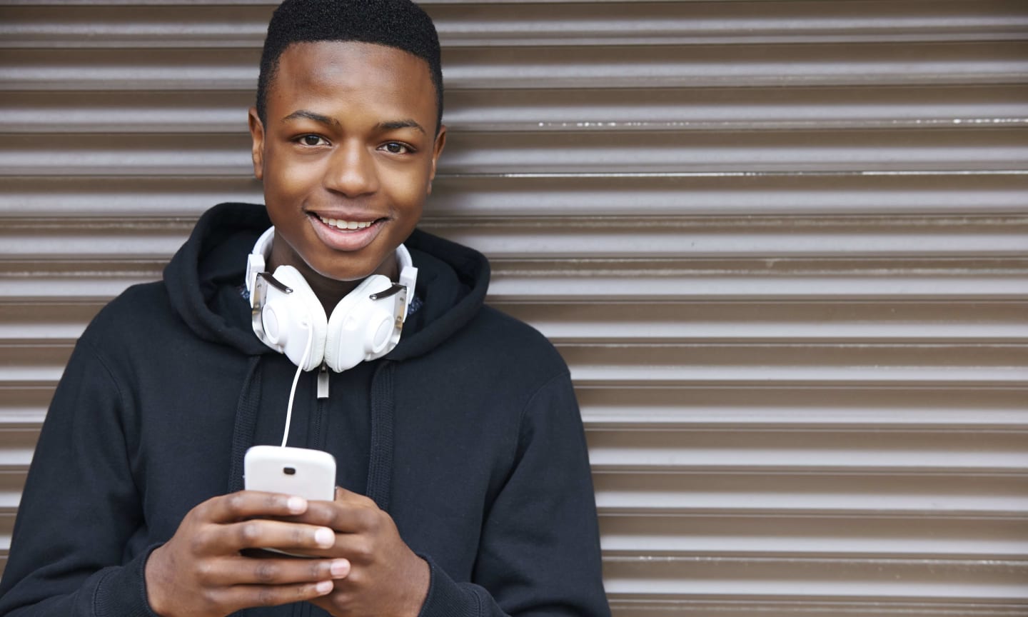 A young person holding a cell phone