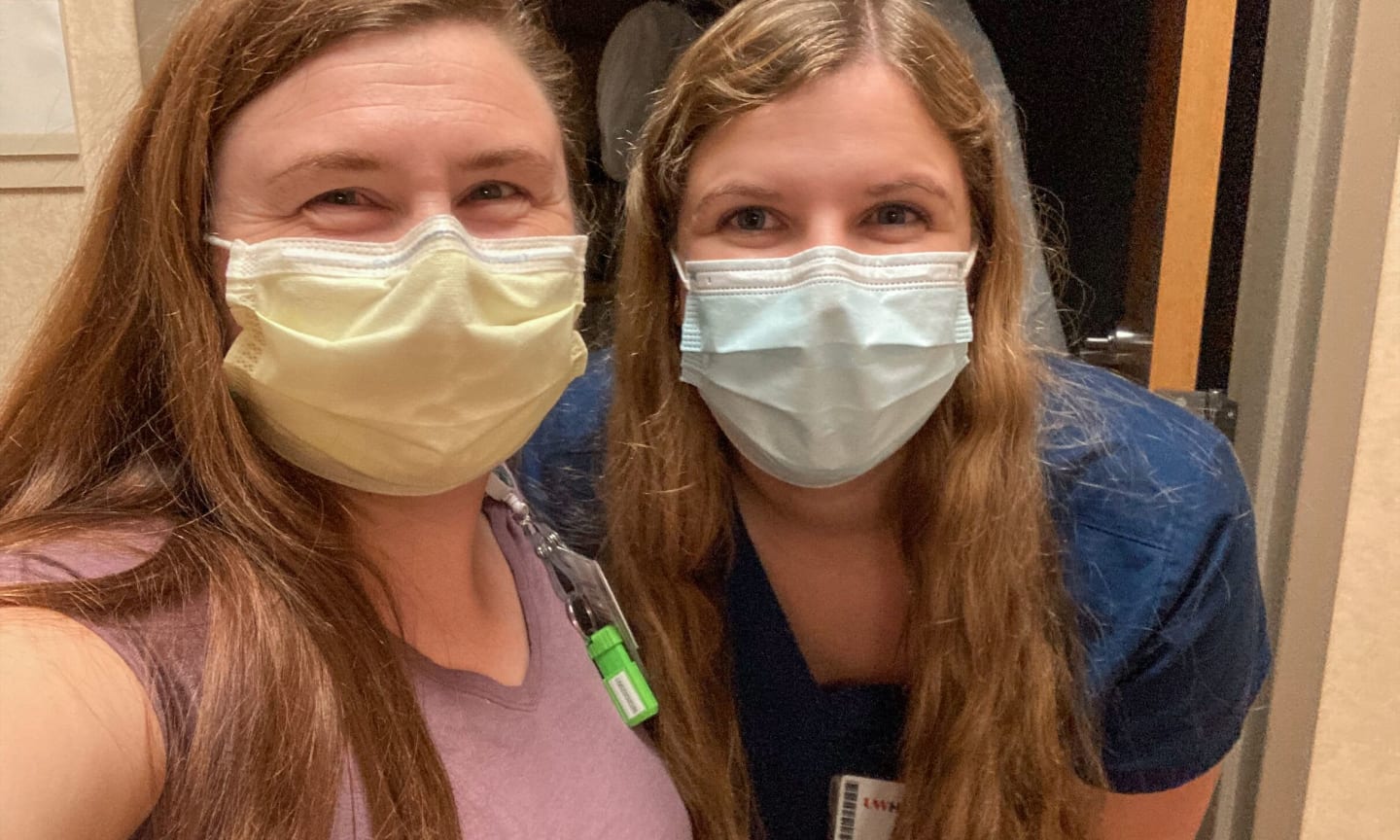 Two women wearing masks