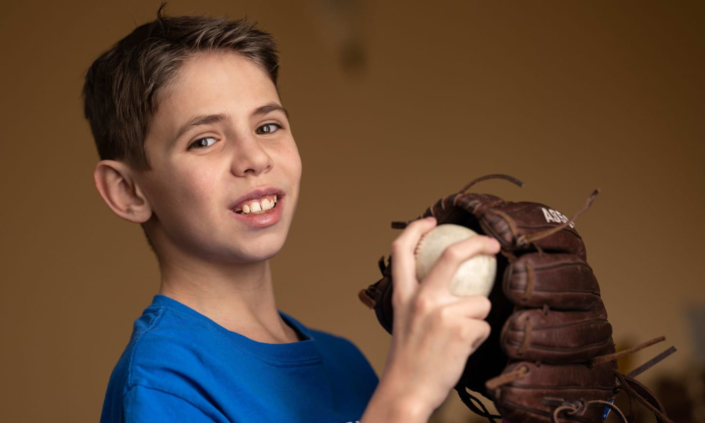 Will Andrews smiling, wearing a baseball glove