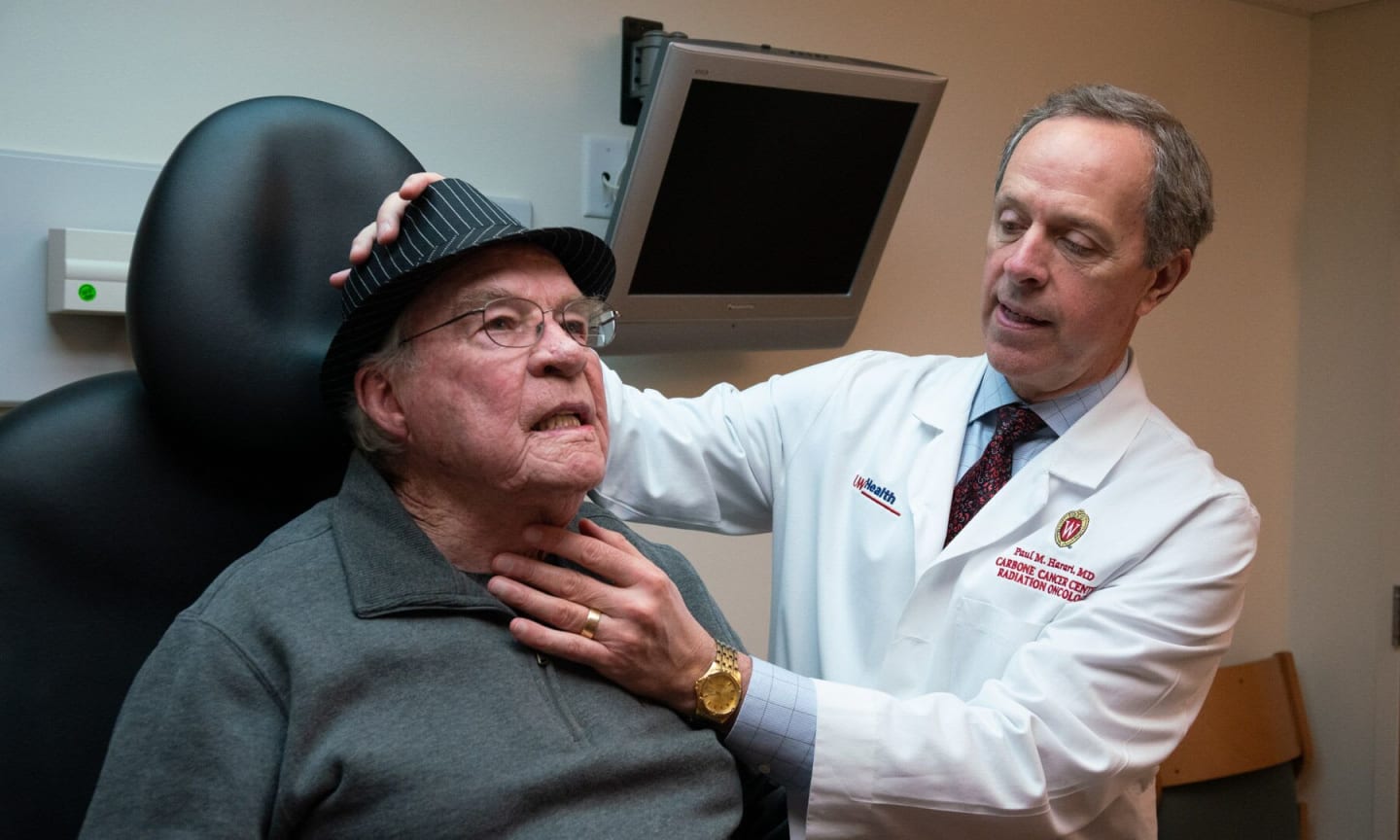 Dr. Paul M. Harari examining a patient's neck