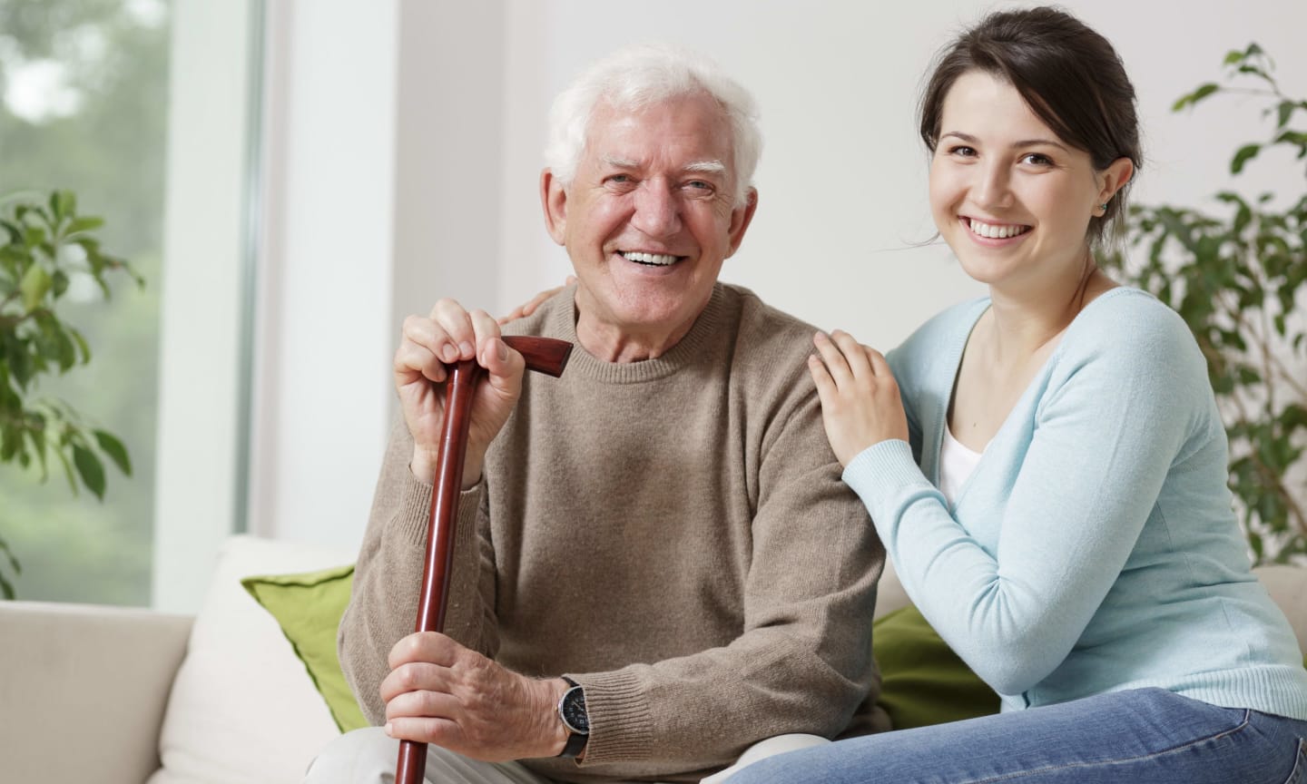 shutterstock_345680966 Older person with a cane sitting with a younger person