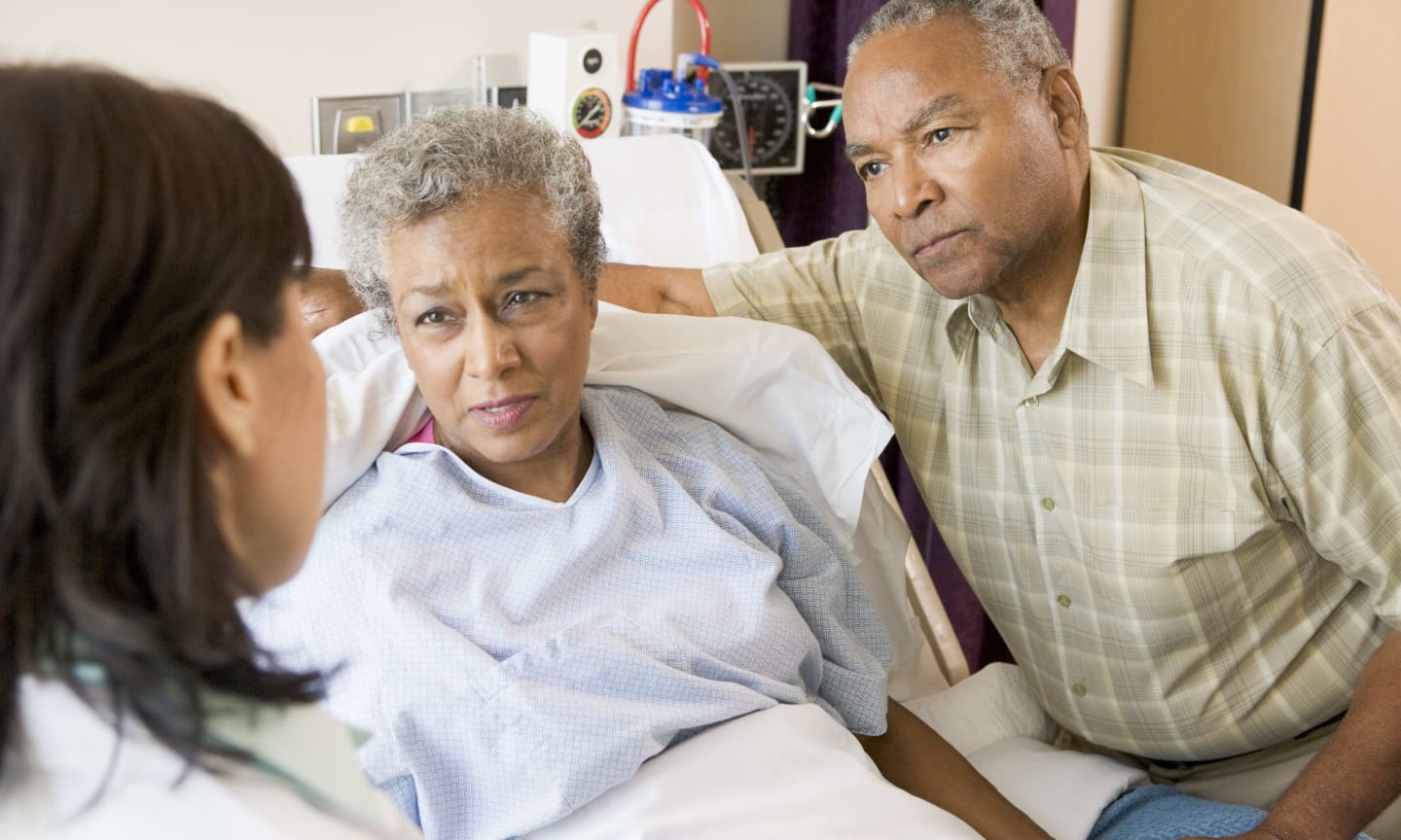 Doctor talking to senior couple