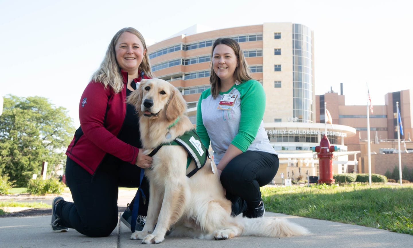 Cola, the newest facility dog at American Family Children's Hospital, with Katie Markowski and Rachel Lodahl