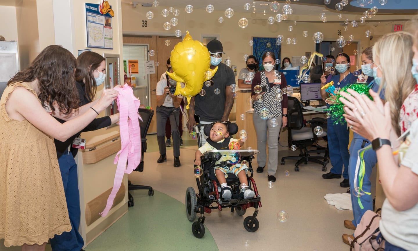UW Health Kids staff celebrate as Kingston Vang Wraggs is discharged from American Family Children's Hospital.